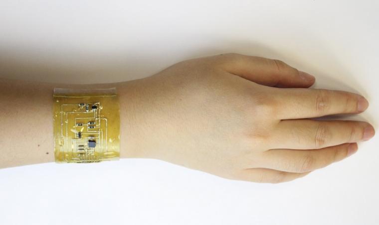A person wears an electronic skin device on the wrist.