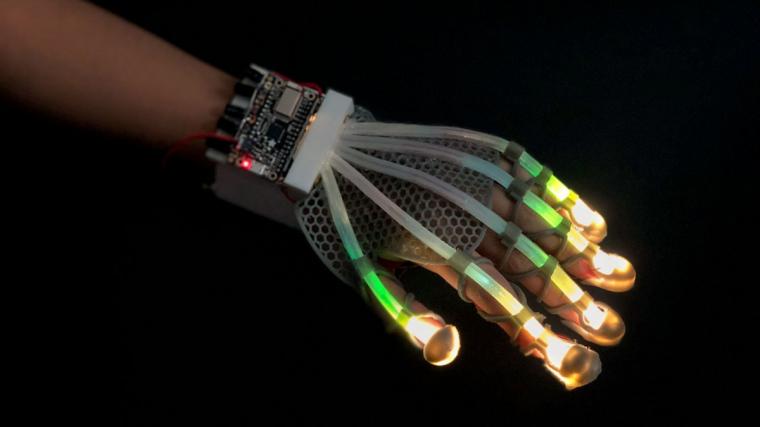 The researchers designed a 3D-printed glove lined with stretchable fiber-optic...
