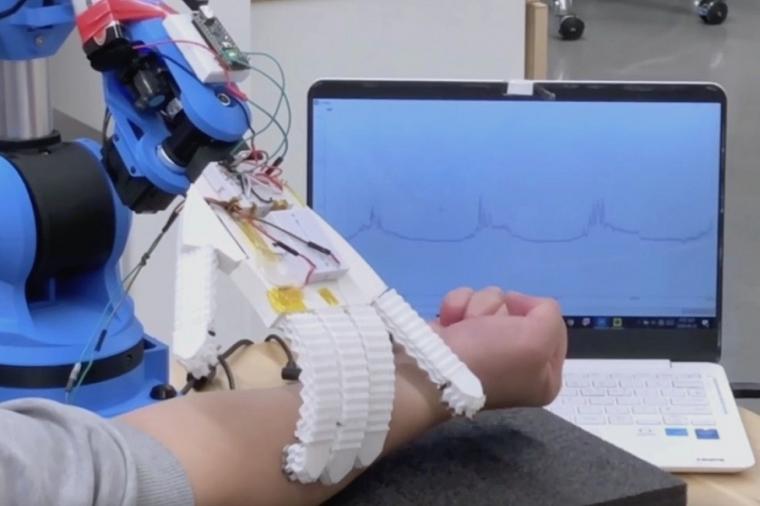 The robotic arm monitors electrical signals.