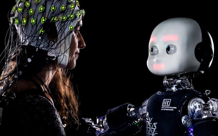 Woman looks at humanoid robot.