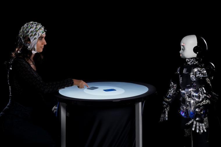 woman and humanoid robot stare at each other