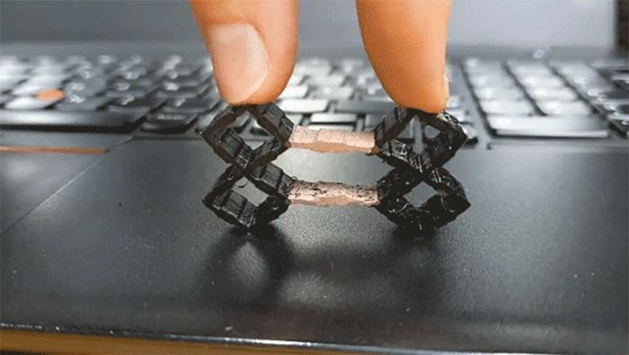 This flexible input device has been 3D printed in one piece with copper-colored...