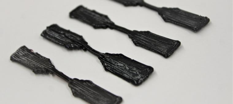 3D-printed dog-bone-shaped nanocomposite specimens.