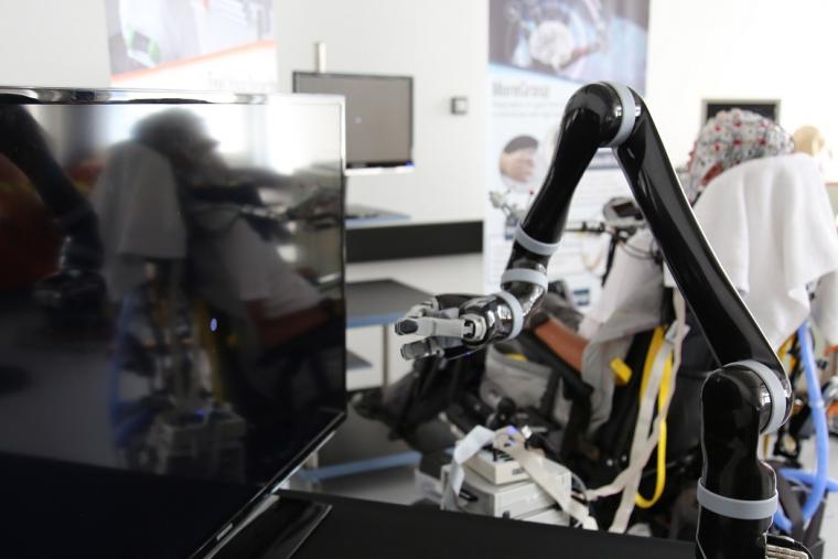A robotic arm (in front) controlled by the test person (behind)
