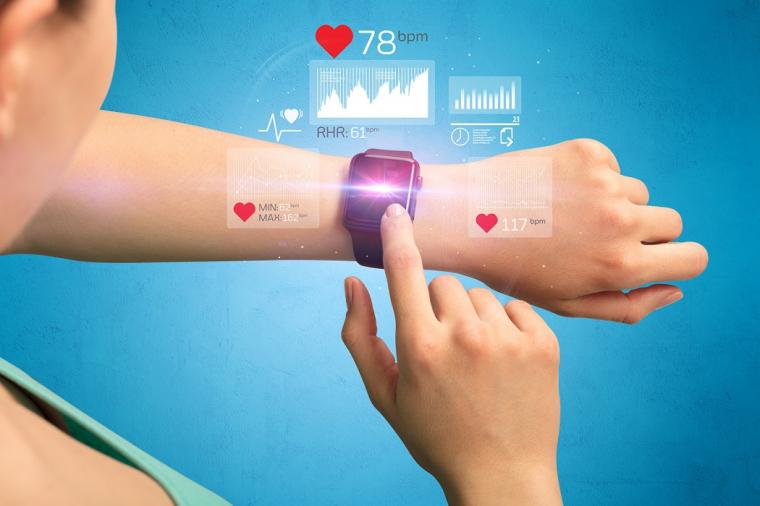 Female hand with smartwatch and health application icons