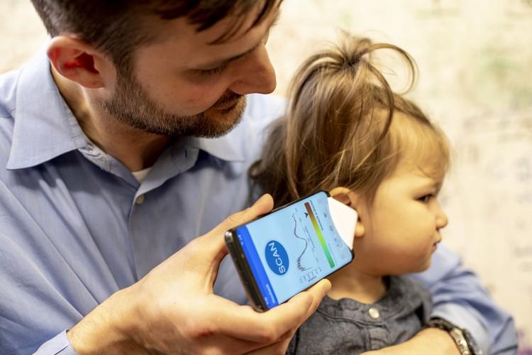 Dr. Randall Bly uses the app to check his daughter’s ear.