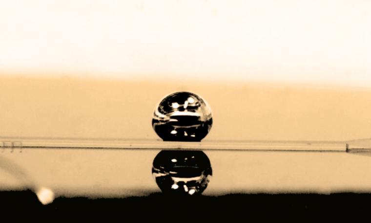 Liquid metal drop, used to make the mini-centrifuge, sits on the channel where...
