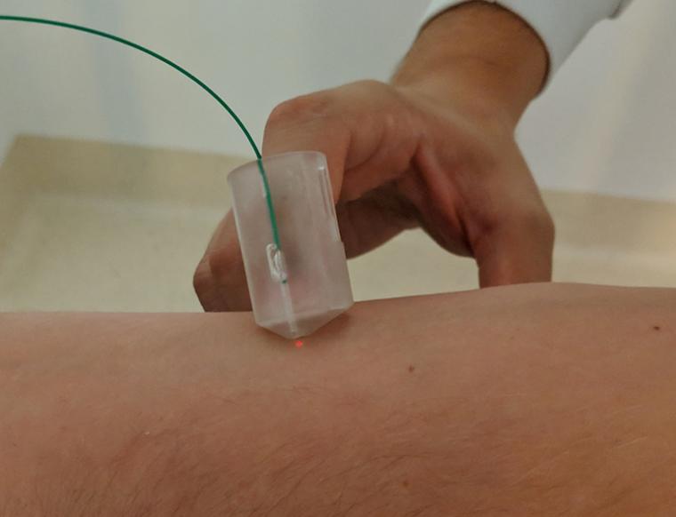 To use the device, the finger-mounted probe is placed perpendicular to the body...