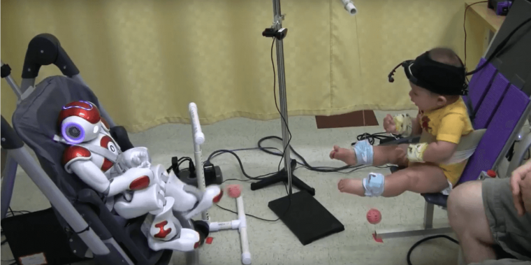 An infant interacts with the Nao robot.