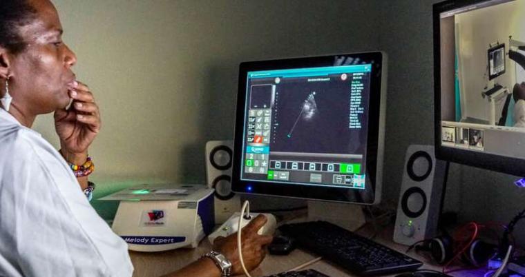 Radiologist uses dummy to manipulate ultrasound probe remotely.