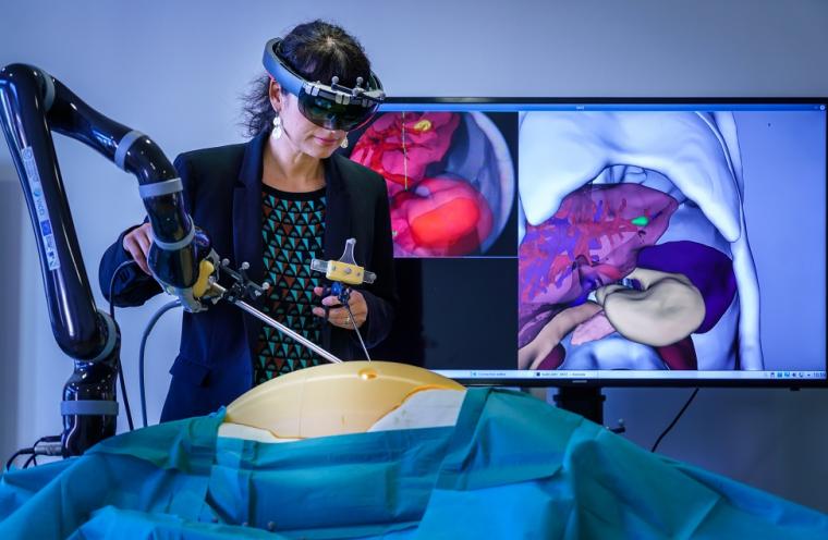 A robotic arm that guides the endoscope could support the surgeon in the...