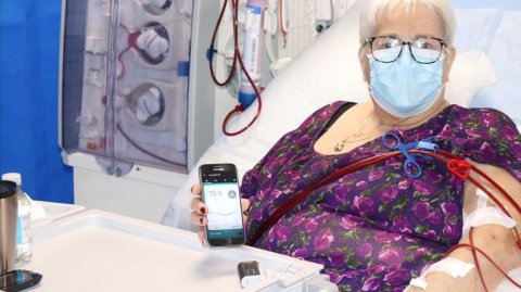 Patient holds smartphone